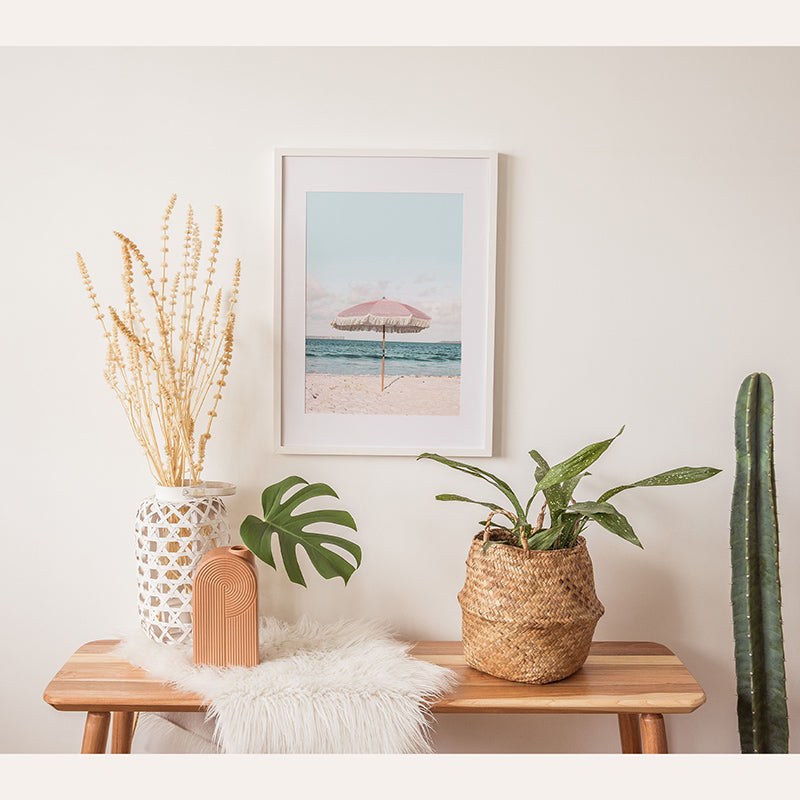 a wooden table topped with a potted plant next to a potted plant