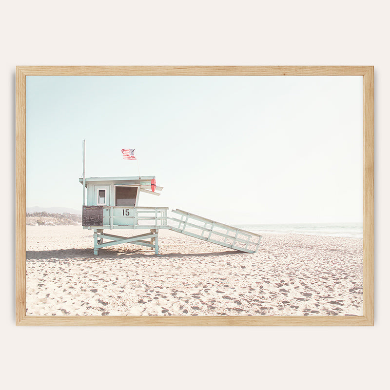 a lifeguard stand on the beach with a life guard flag