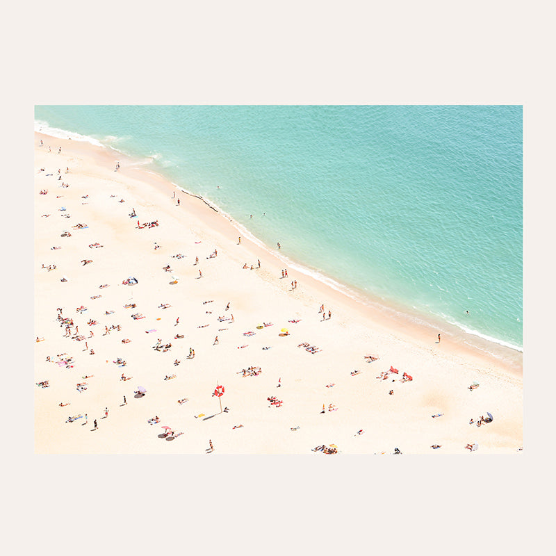 a group of people standing on top of a sandy beach