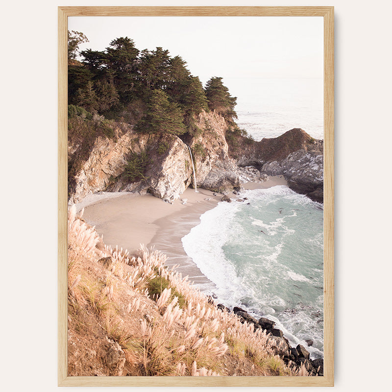 a picture of a beach with a cliff in the background