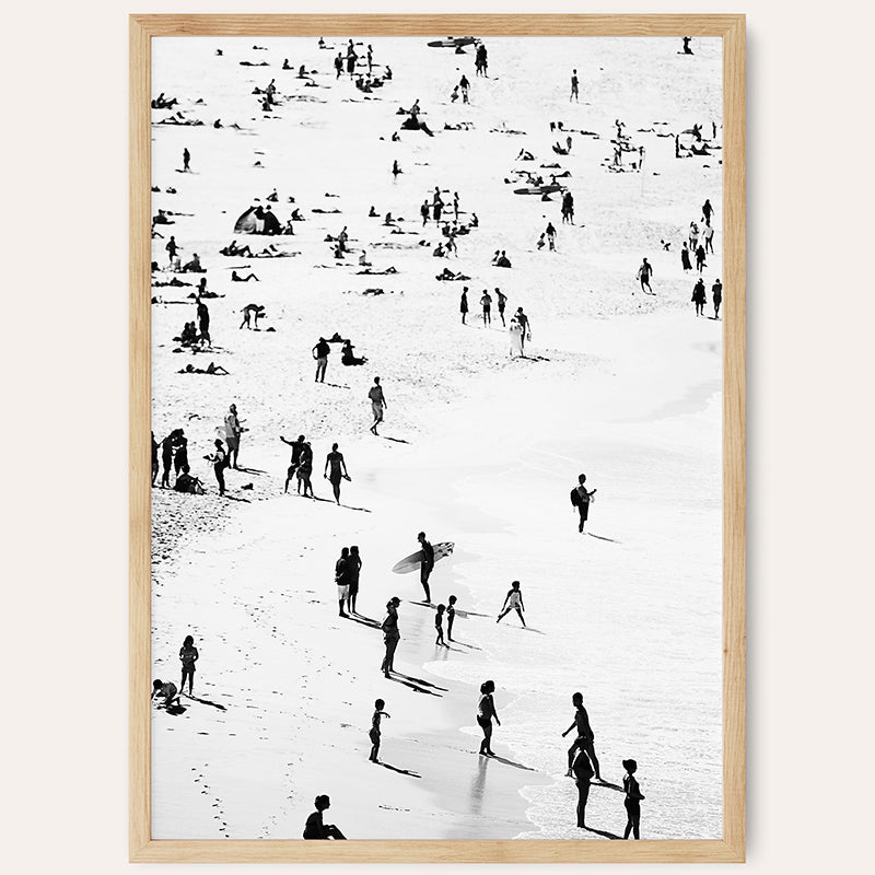 a black and white photo of people on a beach