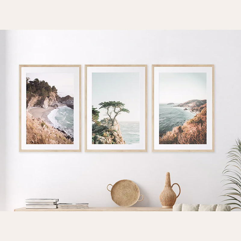 a living room with three pictures hanging on the wall