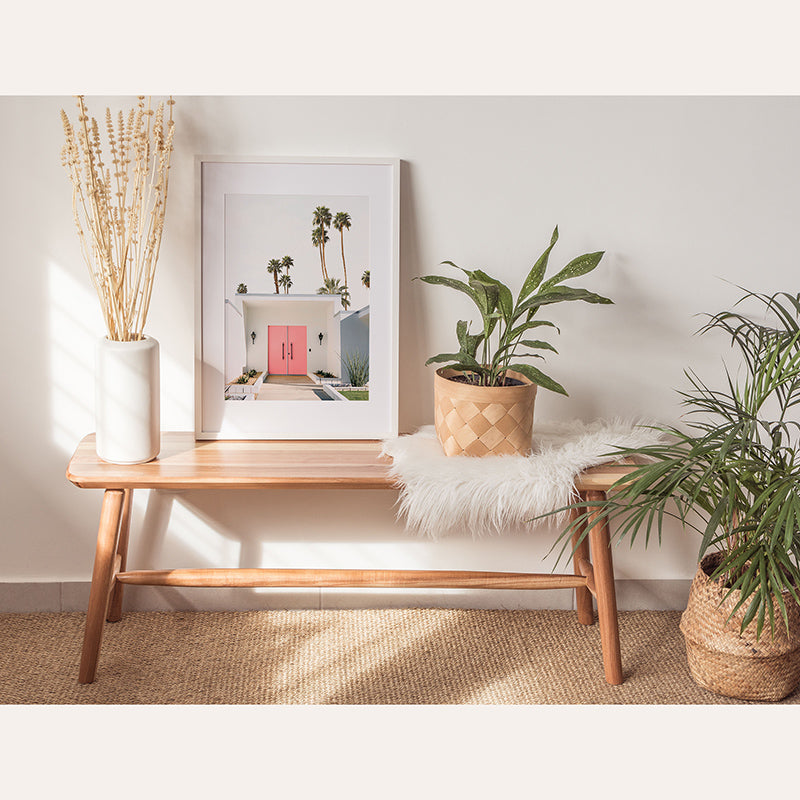 a table with a plant and a picture on it