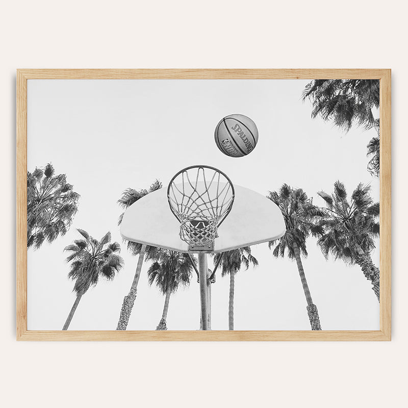 a black and white photo of a basketball going through a hoop