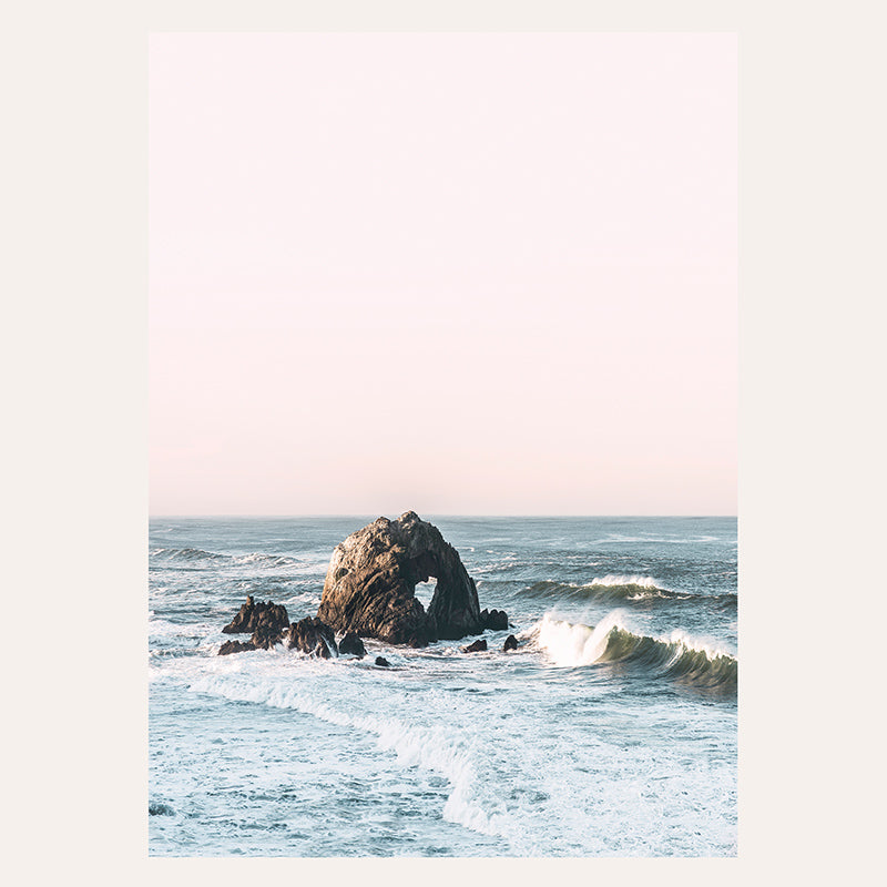 a rocky outcropping in the middle of the ocean