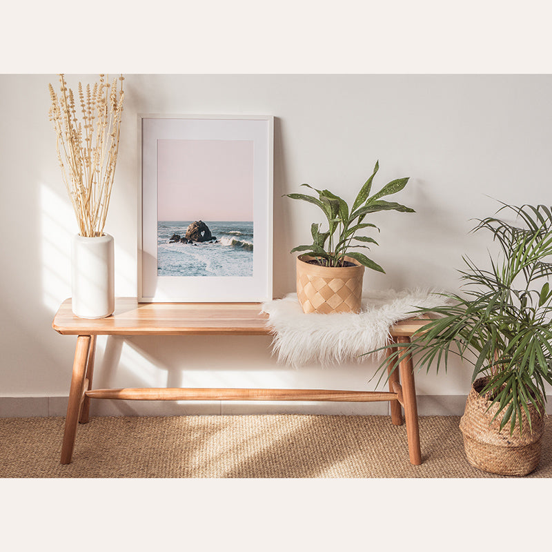 a table with a plant and a picture on it