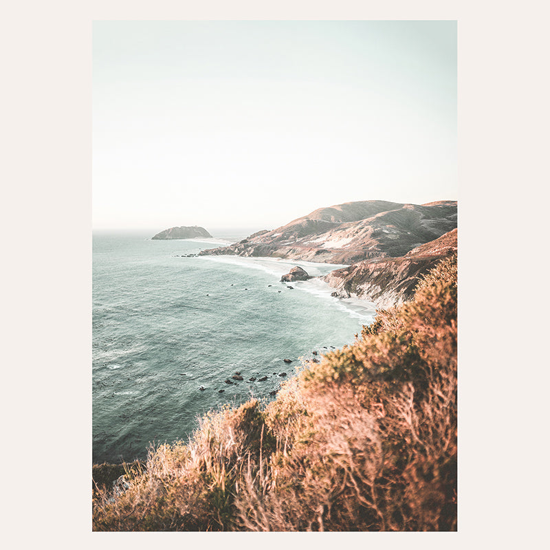 a view of the ocean from the top of a hill