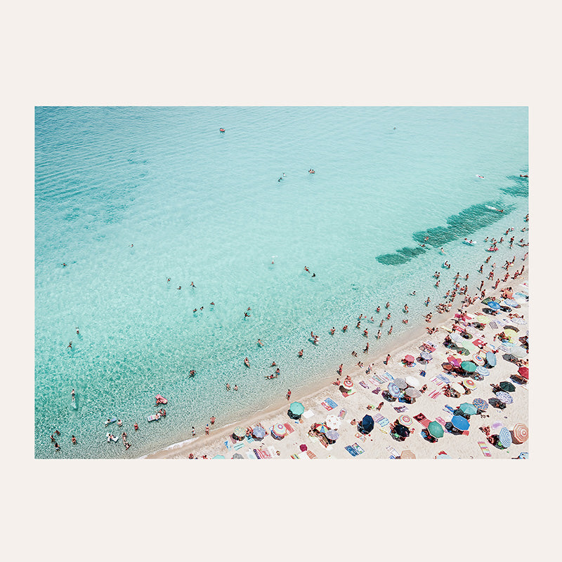 a group of people on a beach with umbrellas