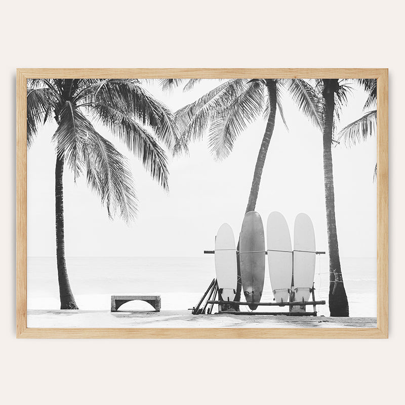 a black and white photo of surfboards on a beach