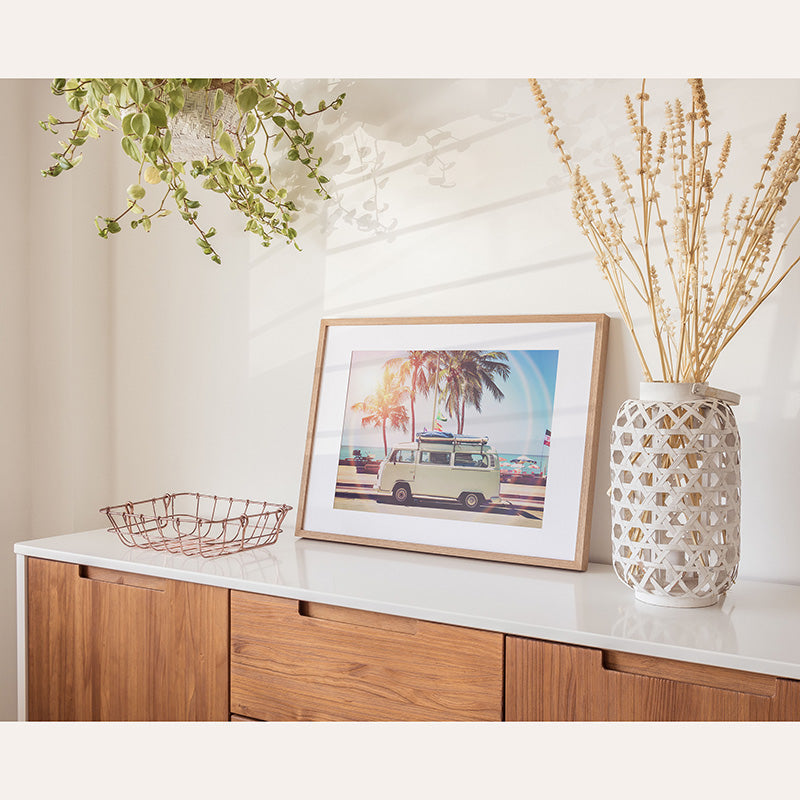 a picture of a car is on a shelf next to a basket