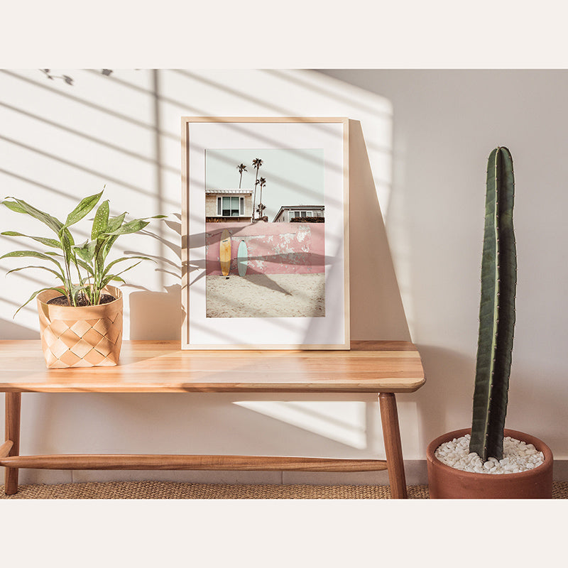 a picture of a house on a table next to a cactus