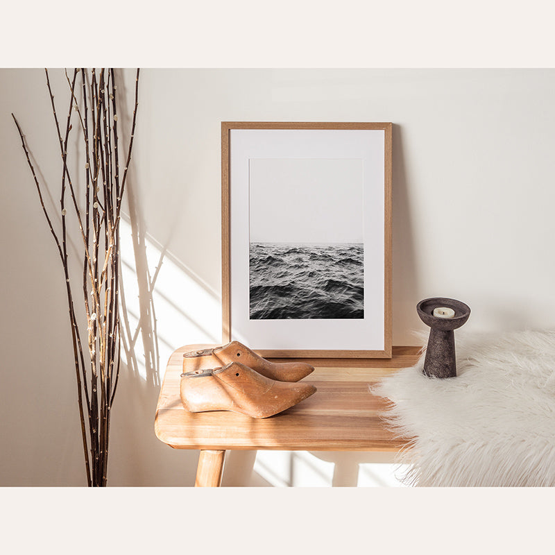 a picture of the ocean in a frame on a table