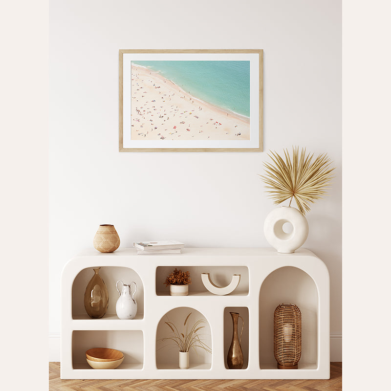 a picture of a beach is hanging on the wall