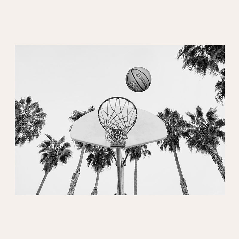 a basketball is in the air above a basketball hoop