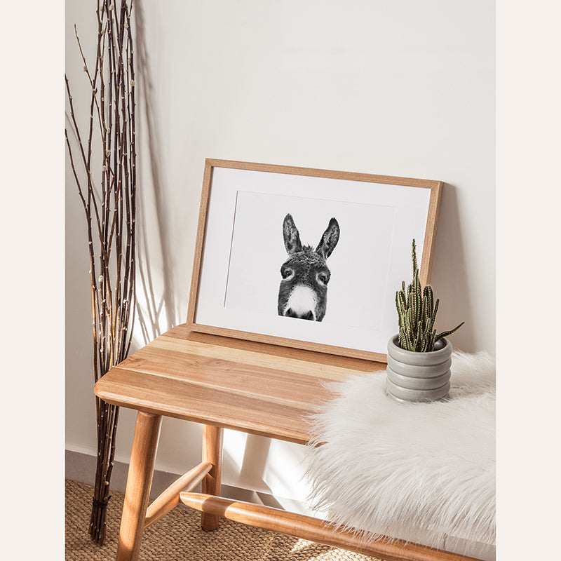 a picture of a rabbit on a table next to a potted plant