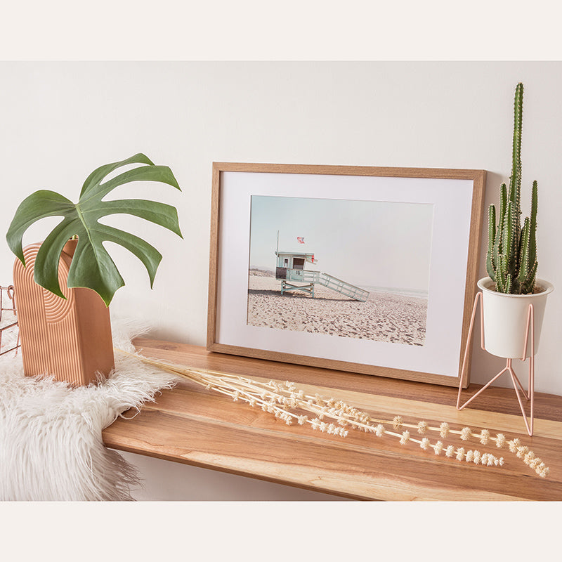 a picture of a lifeguard station on a shelf next to a potted plant