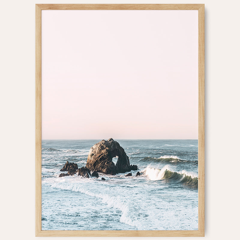 a picture of a rock in the ocean