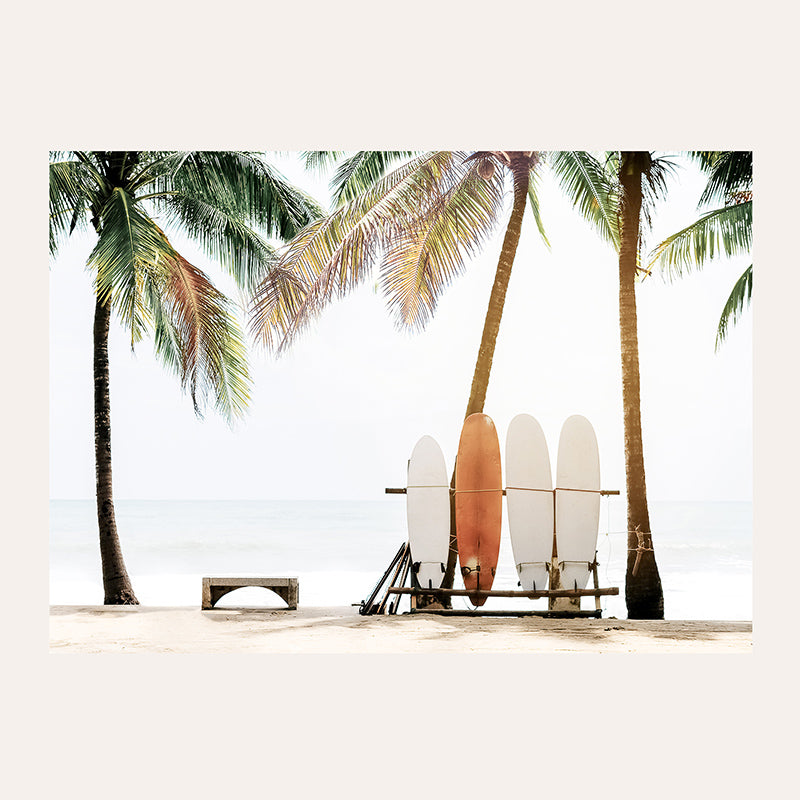 a couple of surfboards sitting on top of a beach