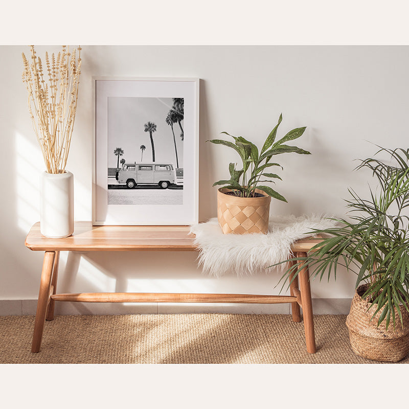 a table with a plant and a picture on it