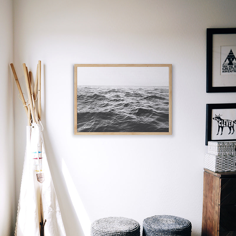 a room with two stools and a picture on the wall