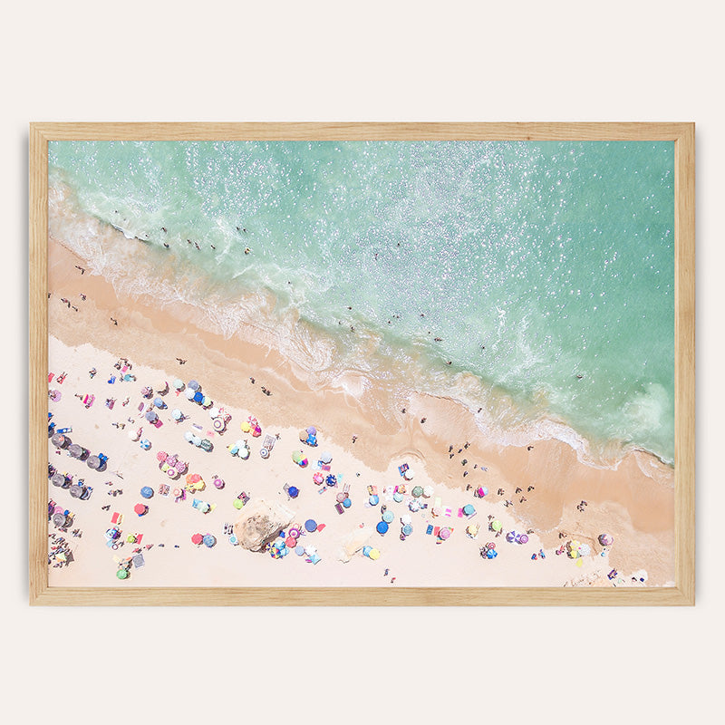 an aerial view of a beach with people and umbrellas