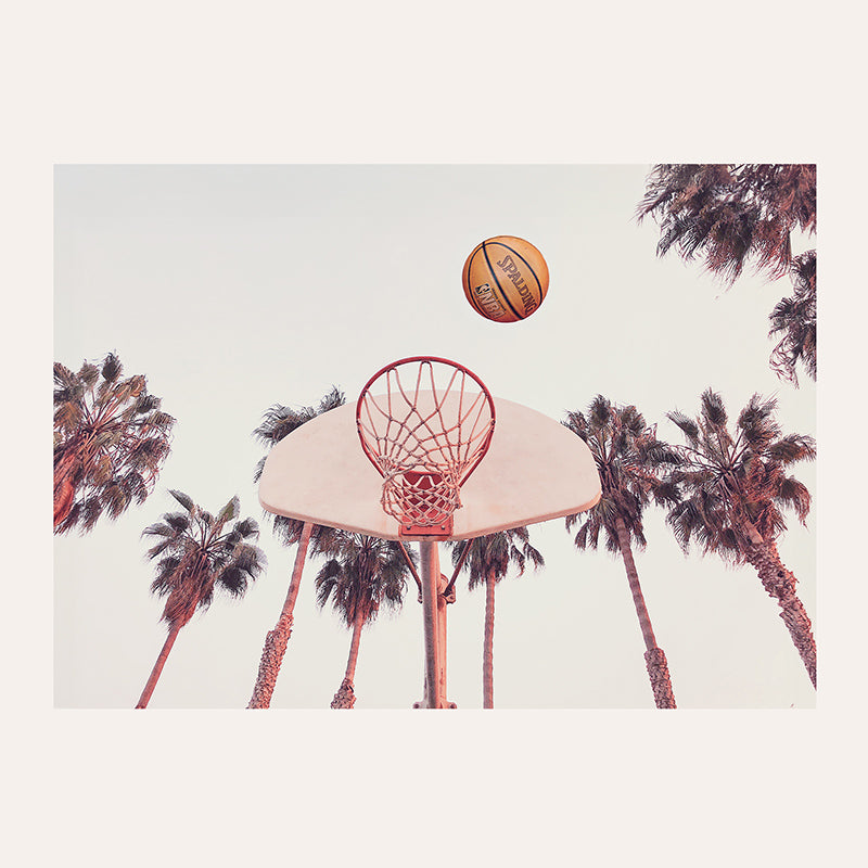 a basketball is in the air above a basketball hoop