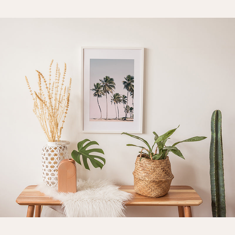 a wooden table topped with plants and a potted plant