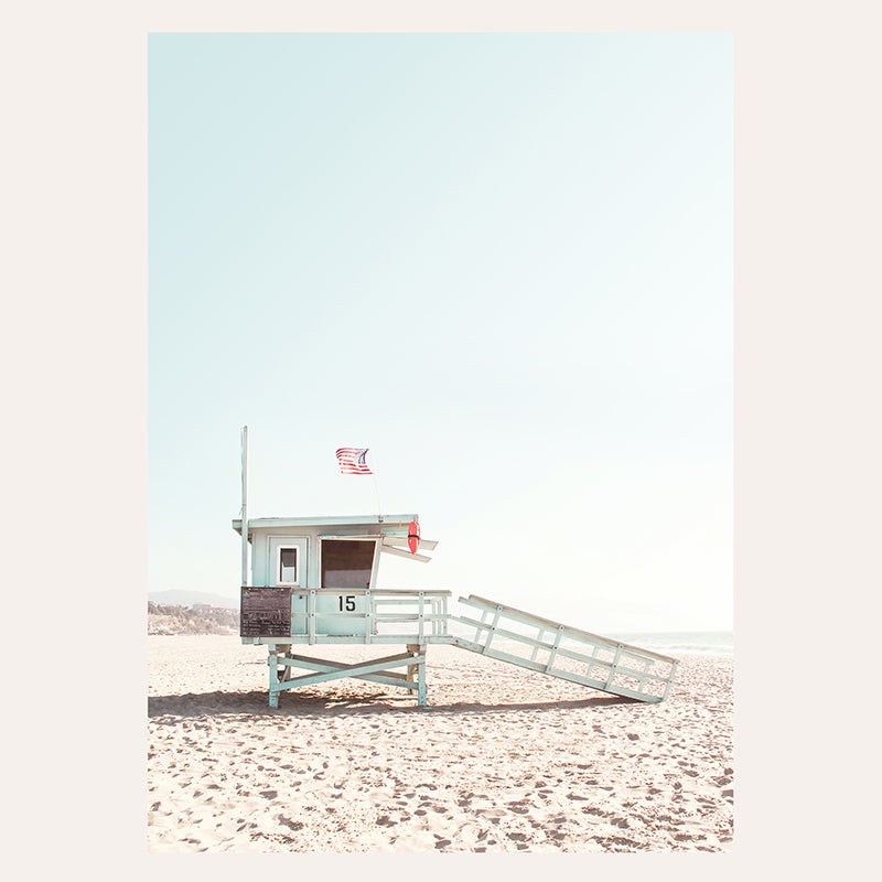 a lifeguard tower on the beach with a ladder leading to it