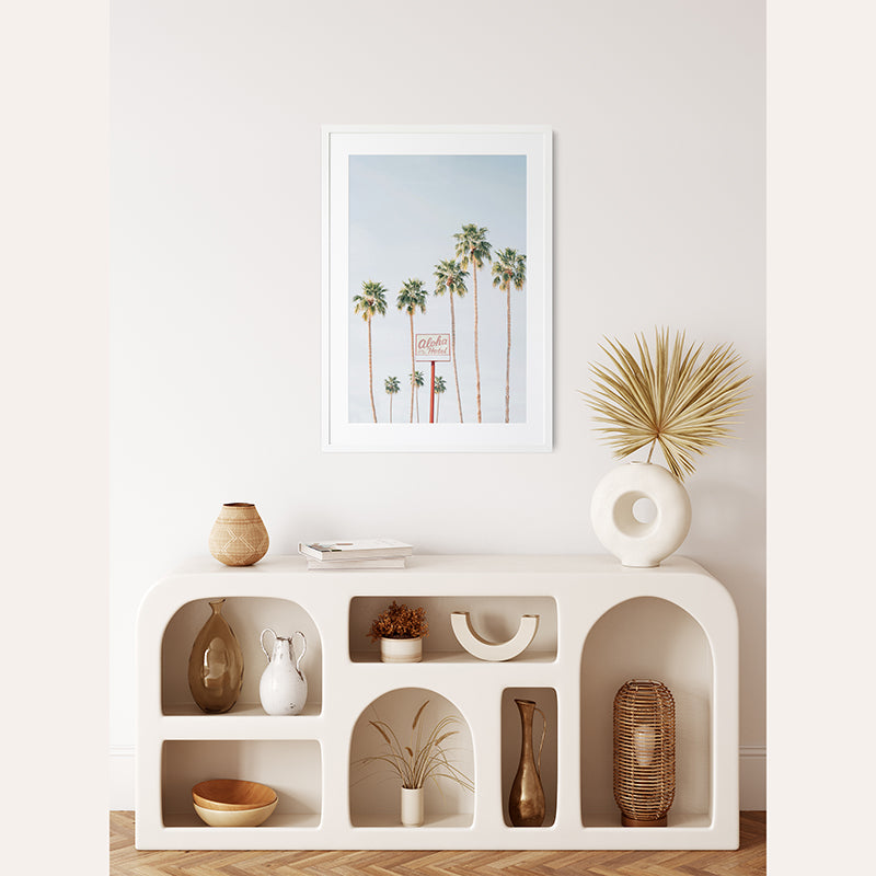 a white shelf with a picture and a vase on top of it