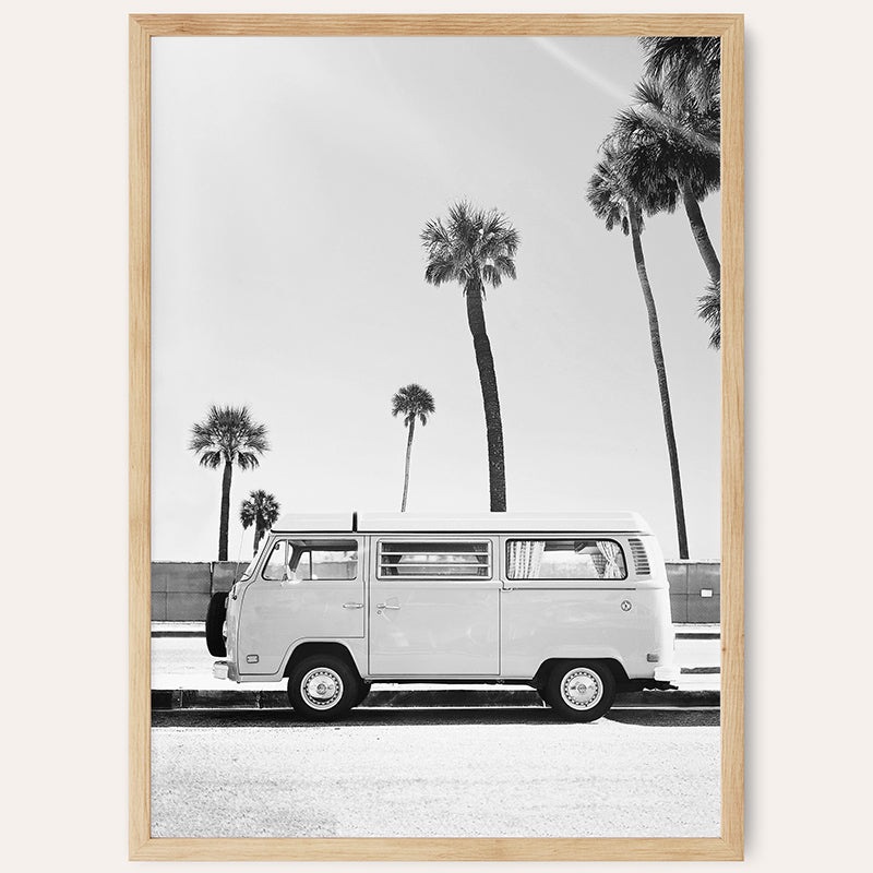 a black and white photo of a van parked on the side of the road